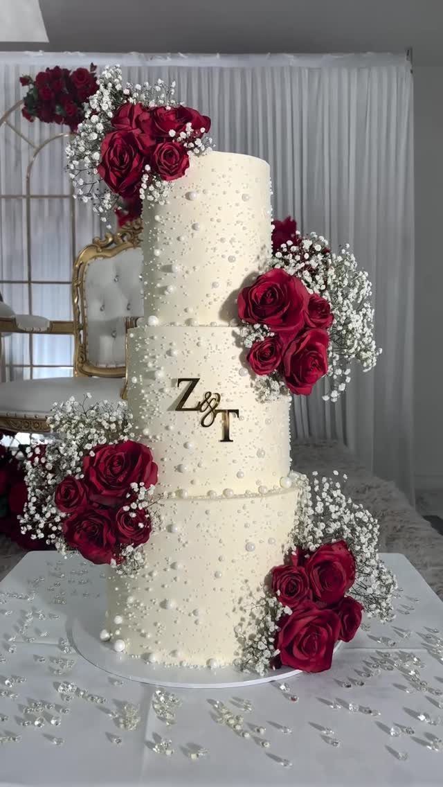 10 Burgundy Wedding Theme Ideas for Tables, Cakes and Attire 5 Three-tiered white pearl-decorated wedding cake with burgundy roses and baby's breath.