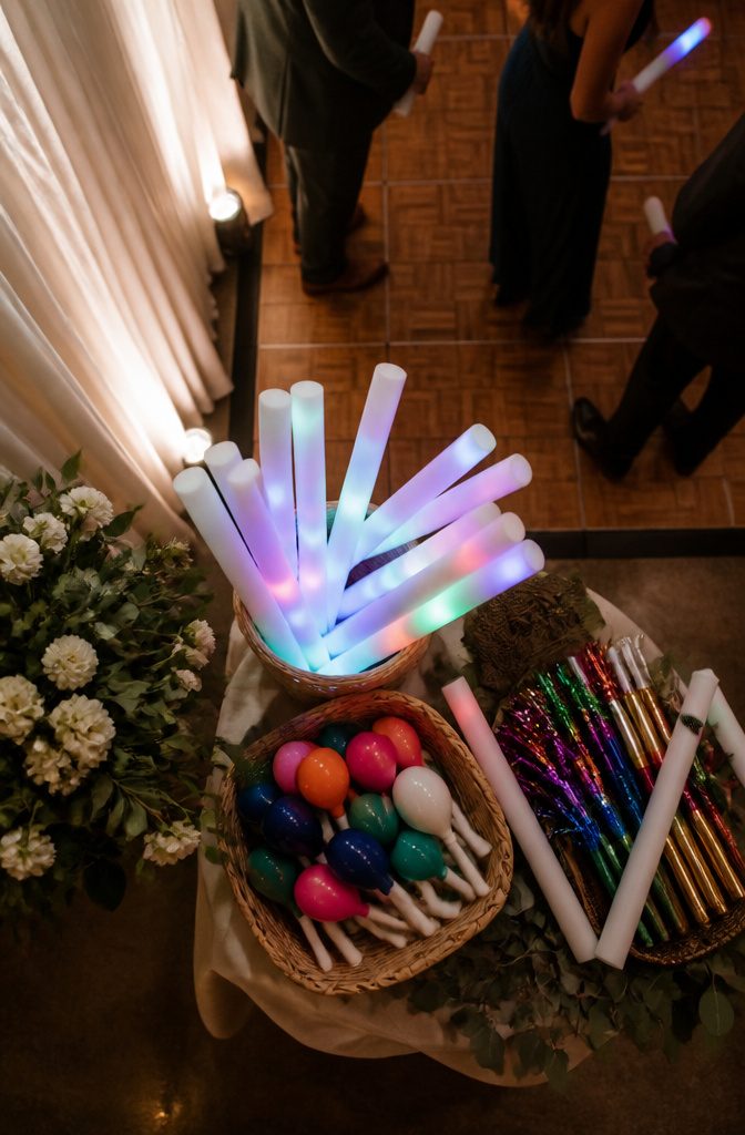 Wedding Dance Floors: Vinyl, Checkerboard, LED, and Monogram Styles 7 Various dance floor props including light-up foam sticks and noisemakers.