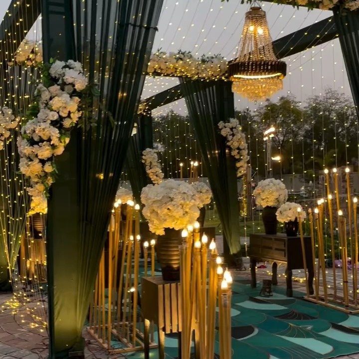 Dark Green Wedding: 13 Ideas for a Forest Reception 10 Dark green wedding drapes decorated with white flowers and hanging fairy lights.