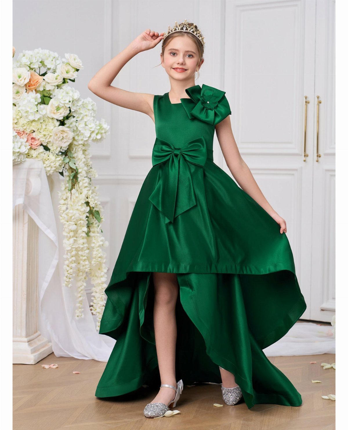 Dark Green Wedding: 13 Ideas for a Forest Reception 7 A young girl posing in a dark green satin high-low dress and a gold tiara.