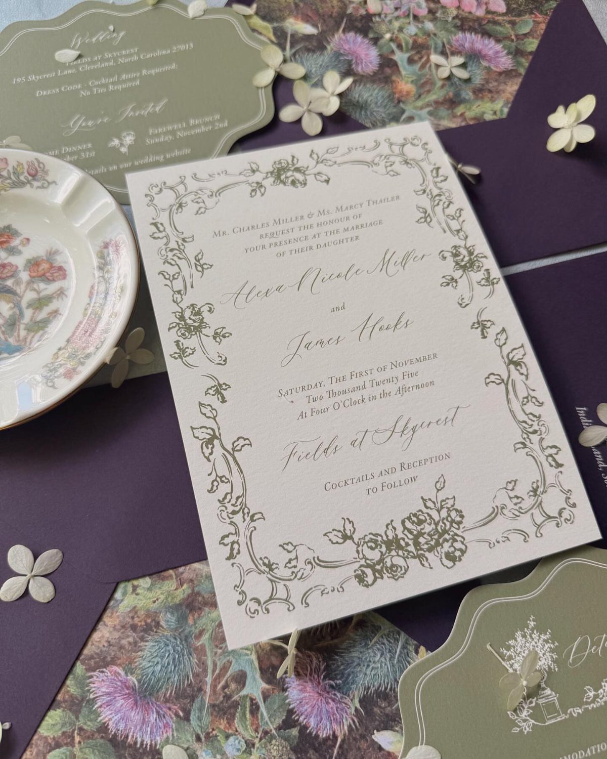 Enchanted Forest Wedding Theme: 10 Ideas for a Natural Setting 3 Wedding invitation with gold floral patterns resting on a dark purple envelope with botanical stationery.