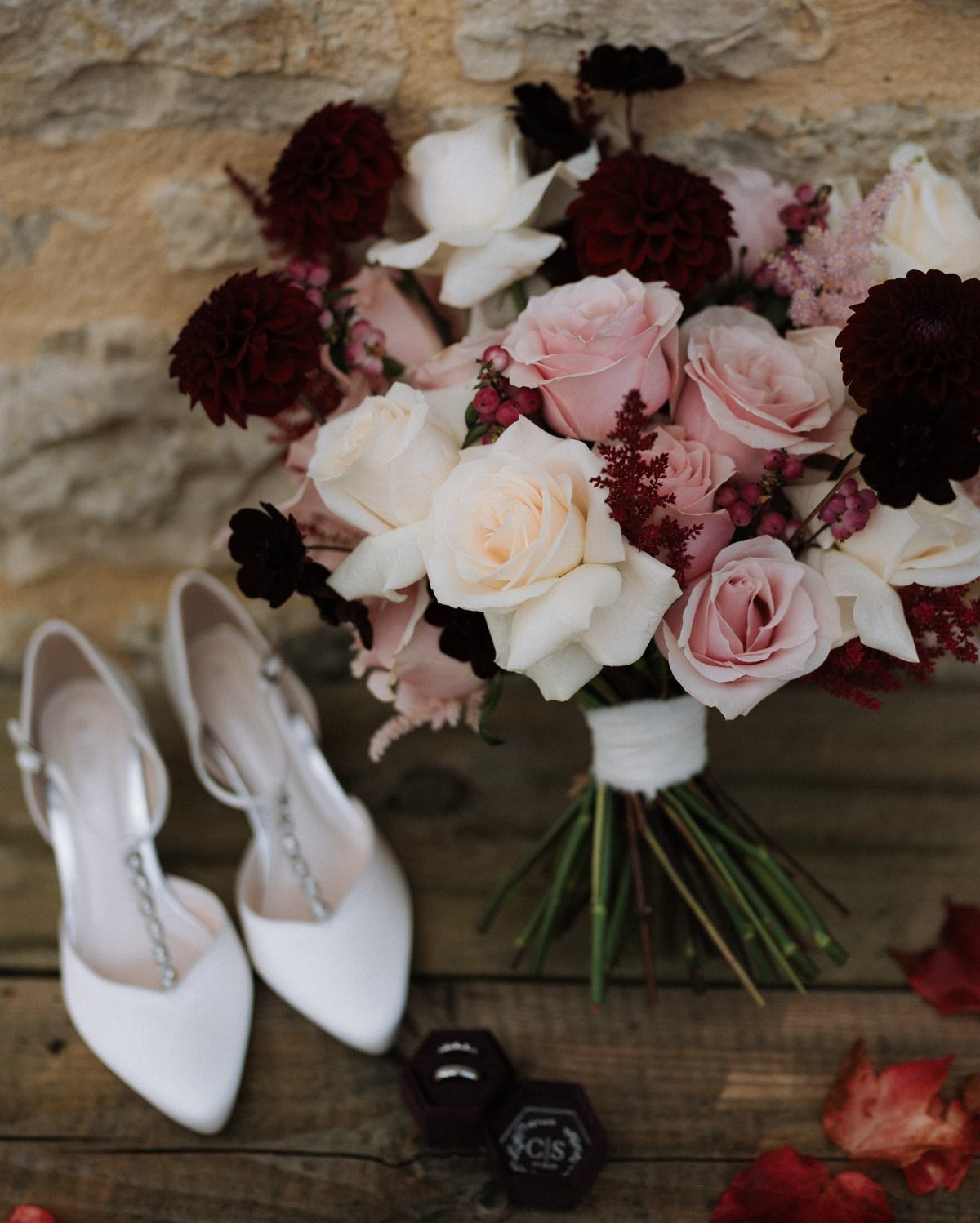 Fall Wedding Color Palette: 10 Ideas Photographed on Real Tables 1 A wedding bouquet with pink and burgundy roses next to white bridal shoes.