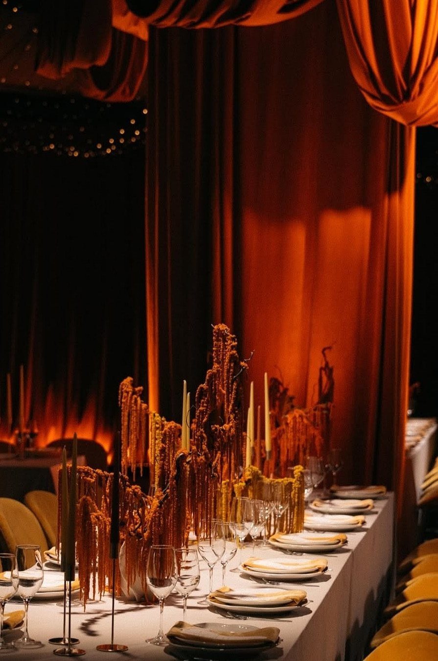 Fall Wedding Color Palette: 10 Ideas Photographed on Real Tables 10 A formal dining table set with white plates and candles against burnt orange curtains.