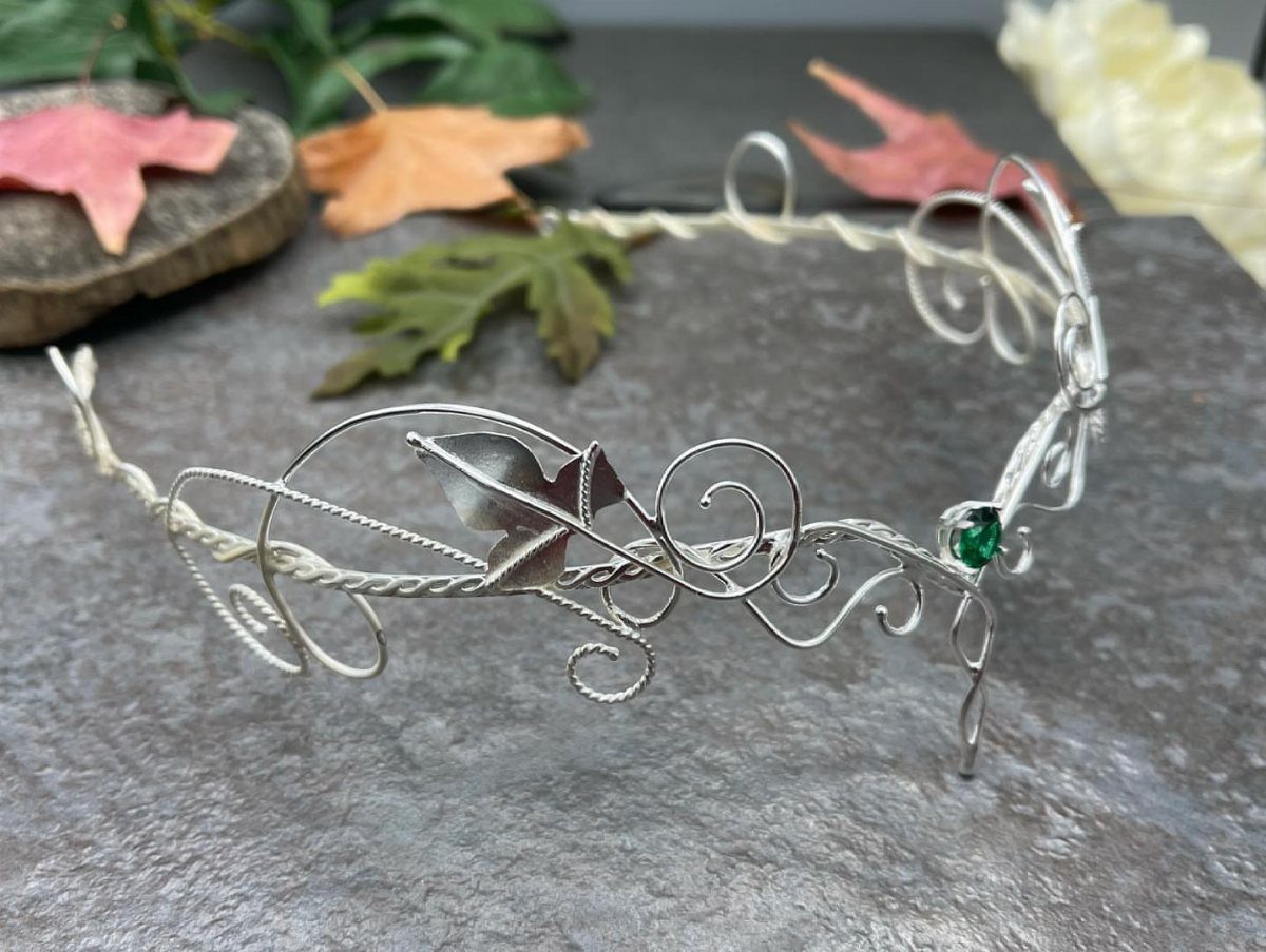 Hobbit Themed Wedding: 20 Ideas for Your Shire Celebration 15 Silver wire tiara with leaf motifs and a green gemstone on a stone surface.
