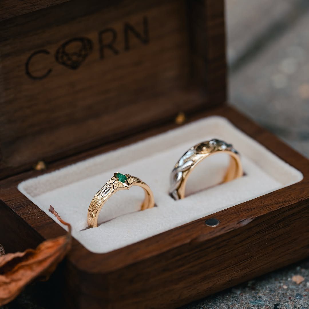 Hobbit Themed Wedding: 20 Ideas for Your Shire Celebration 12 Two gold rings with leaf engravings resting inside a dark wooden jewelry box.