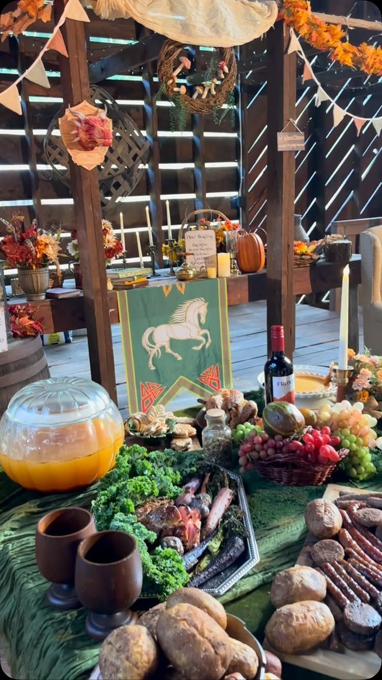 Hobbit Themed Wedding: 20 Ideas for Your Shire Celebration 9 A rustic feast spread with bread, meat, fruit, and a large bowl of orange punch.