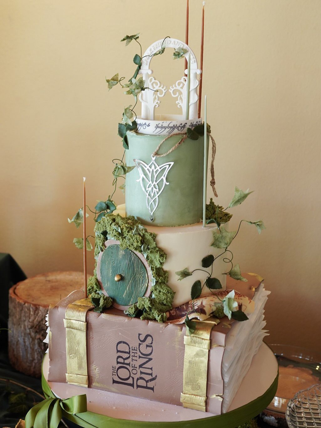 Hobbit Themed Wedding: 20 Ideas for Your Shire Celebration 10 Three-tiered Lord of the Rings themed wedding cake with a book base and hobbit door.
