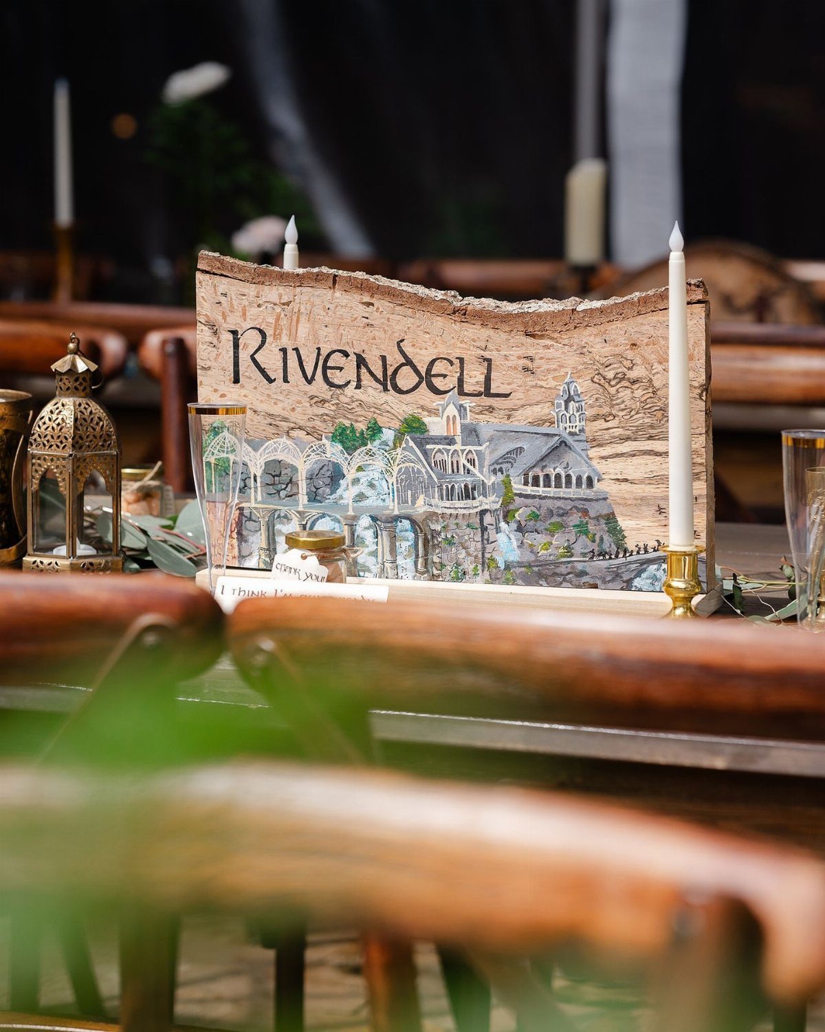 Hobbit Themed Wedding: 20 Ideas for Your Shire Celebration 14 A piece of wood bark featuring the word Rivendell and a fantasy castle illustration.