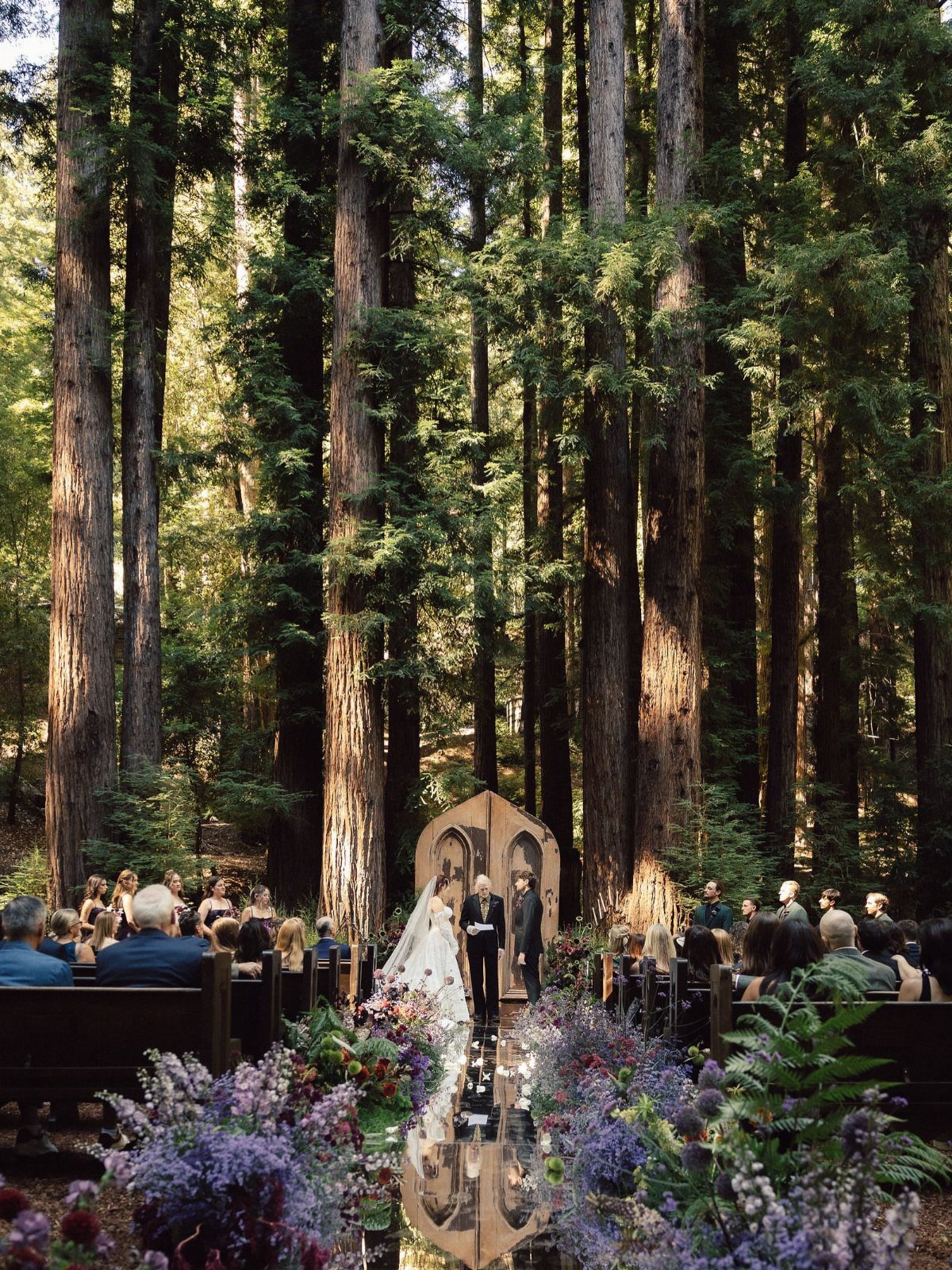 Hobbit Themed Wedding: 20 Ideas for Your Shire Celebration 2 A bride and groom stand at a wooden altar during a forest wedding ceremony.