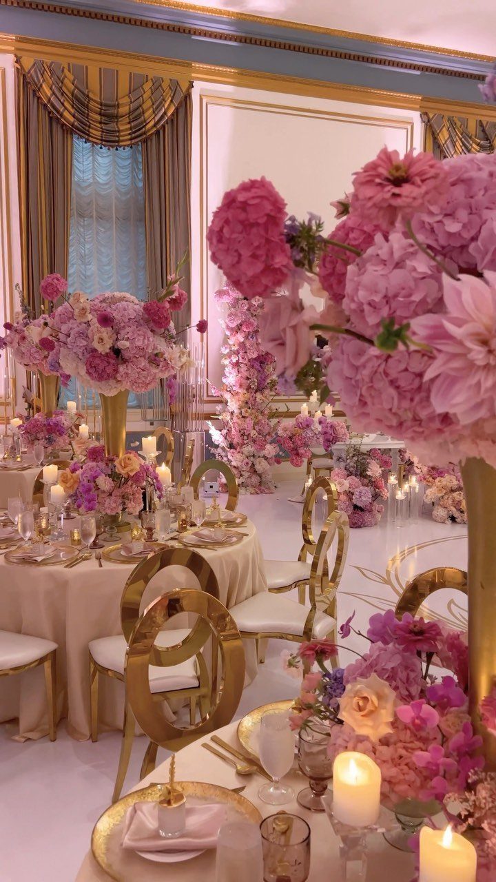 8 Pink Wedding Color Ideas for Every Venue and Season 3 Pink floral centerpieces with blush and hot pink flowers decorate an elegant ballroom wedding reception.