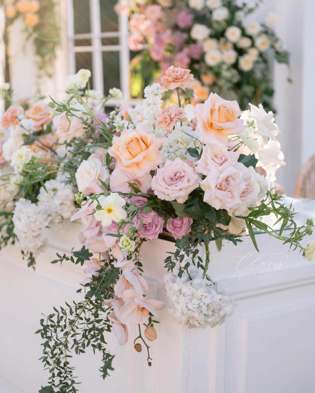 8 Pink Wedding Color Ideas for Every Venue and Season 7 Blush and peach roses with white hydrangeas in a lush floral arrangement.
