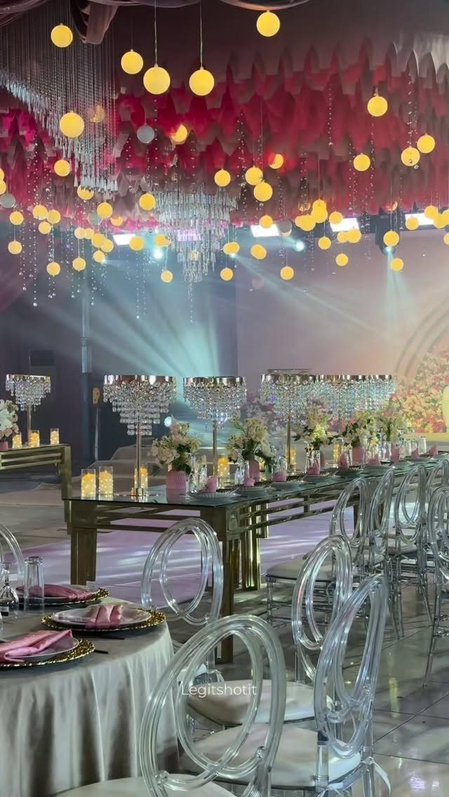 8 Pink Wedding Color Ideas for Every Venue and Season 4 Gold tables and crystal chandeliers set in a pink wedding reception hall.