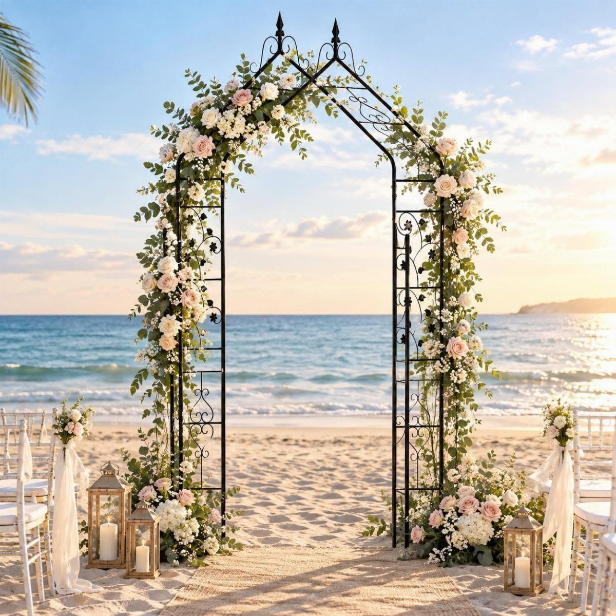 9 Wedding Ceremony Arch Ideas for Indoor and Outdoor Vows 8 A floral metal arch stands on a sandy beach overlooking the ocean at sunset.