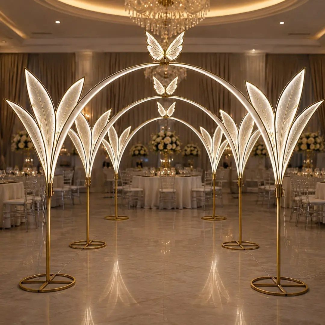 8 Wedding Decor Elegant Ideas for Church and Reception (2026) 4 Glowing leaf-shaped light sculptures forming an illuminated archway in a wedding ballroom setting.