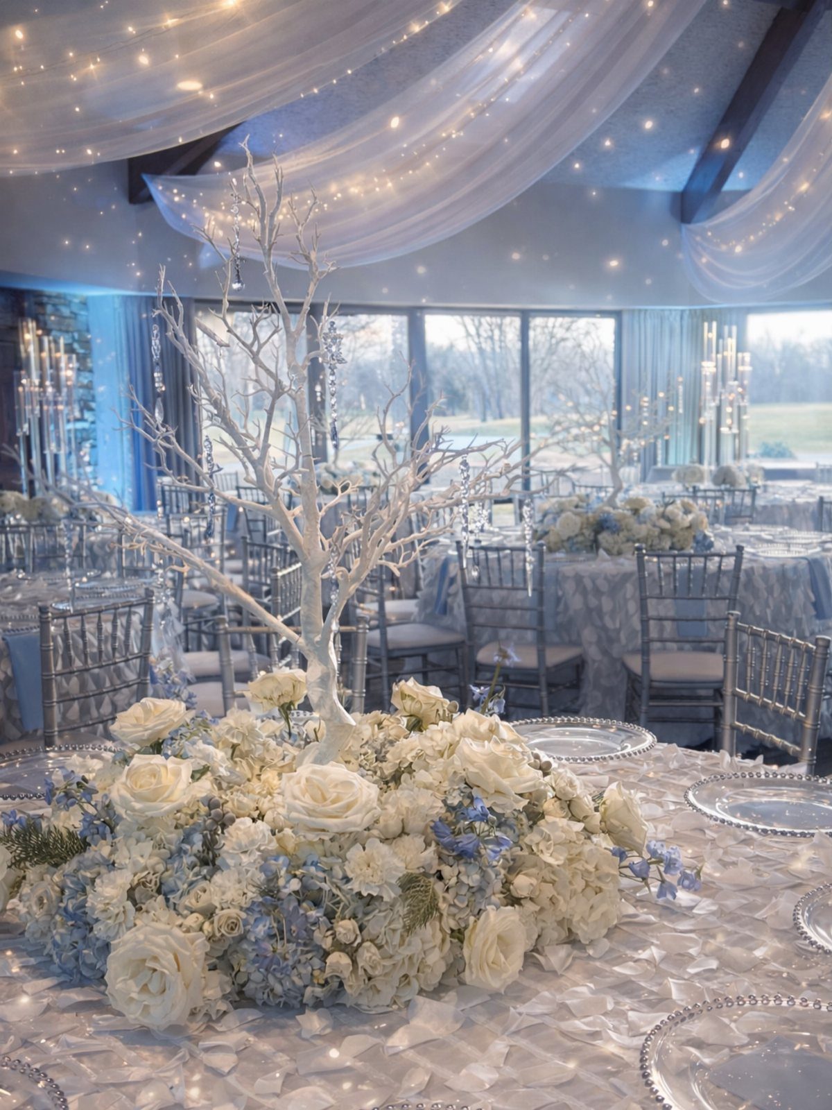 12 Wedding Events Ideas for Your Reception, Ceremony & More 12 White decorative branches and blue and white roses serve as a centerpiece on a wedding reception table.