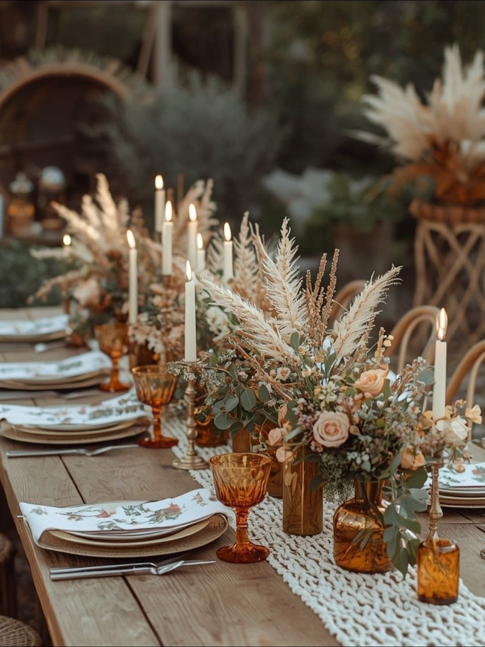 13 Wedding Ideas for Country Ceremonies That Feel Lived-In 10 Rustic table setting with amber glassware, white taper candles, and dried floral arrangements on a wooden table.