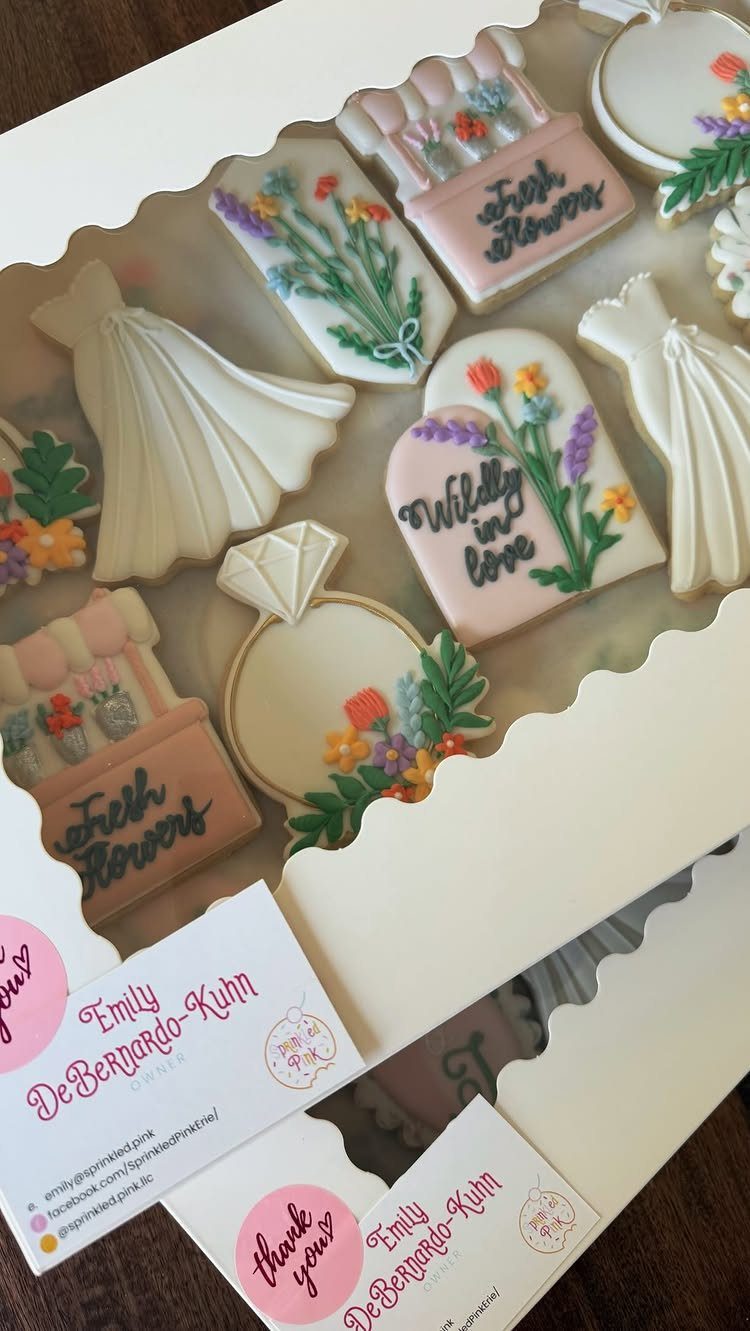 Wildflower Wedding Theme: 13 Ideas for a Light, Natural Day 8 Decorated sugar cookies in various wedding shapes with colorful wildflower icing designs inside a white box.